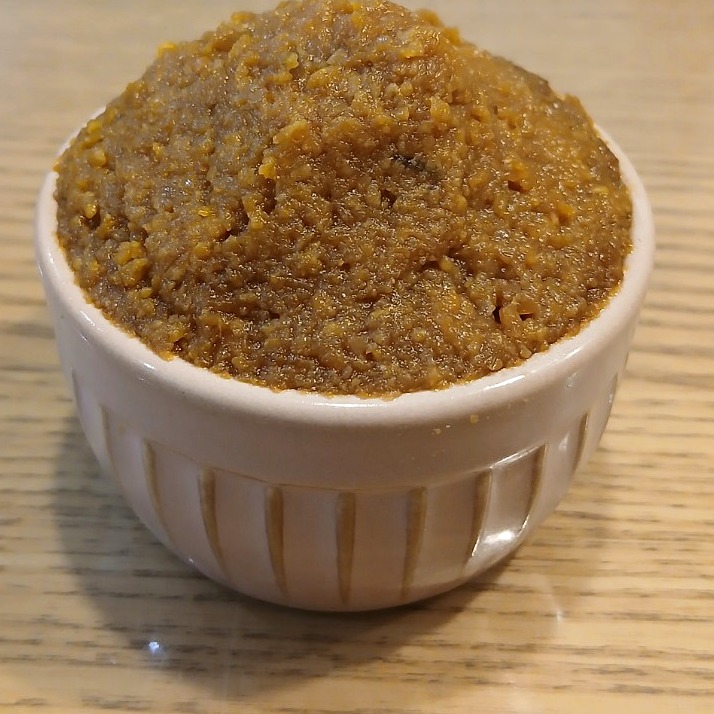 Homemade miso in a small white bowl on a family table in Japan.